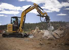 Cat’s new minis and micros have no trouble hoisting hydraulic breakers for tough rock work