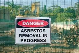 Abestos danger sign on a fence at a work site